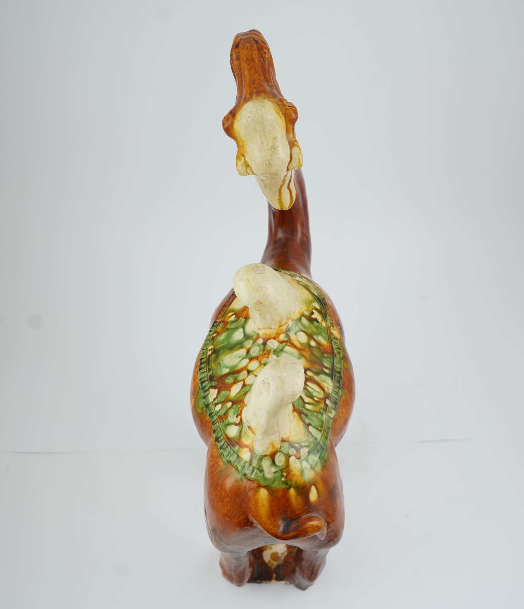 A large Chinese sancai pottery figure of a bactrian camel, Tang dynasty